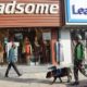 An armed forces personnel equipped with Sniffer dog walk along side a street in Lalchowk. Authorities in Srinagar intensified frisking and forces deployment ahead of G20 Summit in Kashmir. [FPK Photo / Umar Farooq]